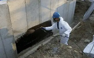 Professional waterproofing the exterior walls of the basement in Charlotte, NC