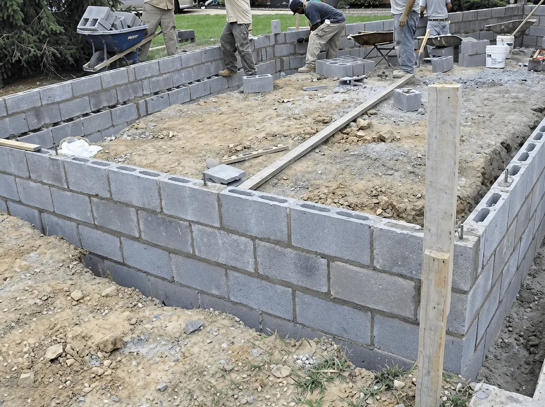 Professionals building a foundation with blocks in Charlotte, NC
