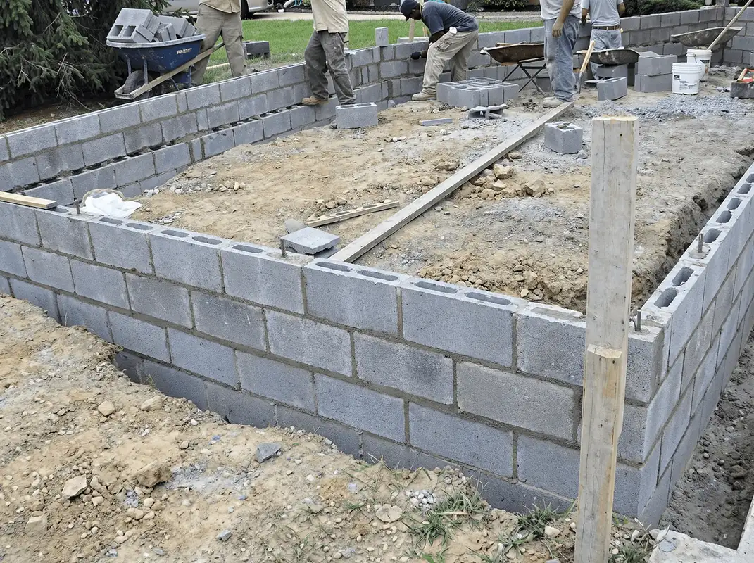 Professionals building a foundation with blocks in Charlotte, NC