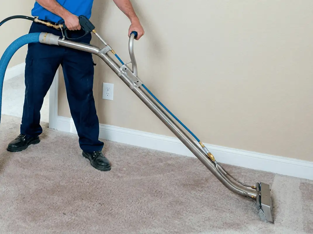 Professional operating a liquid removal machine on a carpeted floor in Charlotte, NC