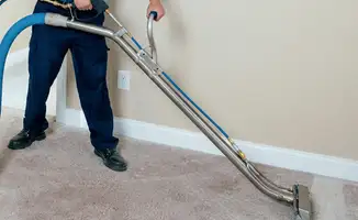 Professional operating a liquid removal machine on a carpeted floor in Charlotte, NC